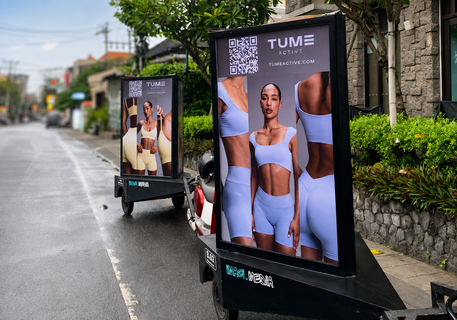 Two Imagi Media mobile billboards on a Bali street displaying a TUME Active activewear campaign.